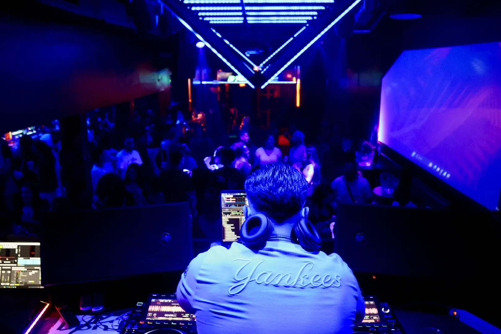 DJ playing under blue stage lights
