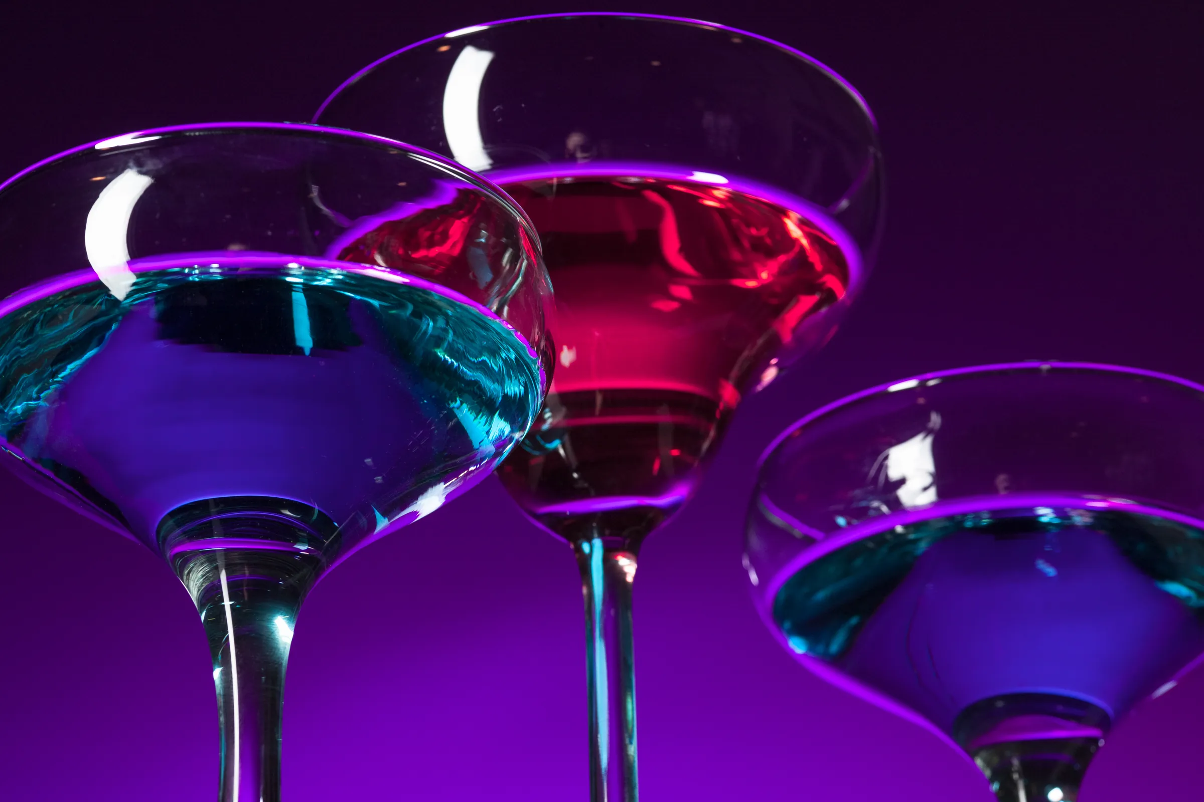 Neon-lit cocktail glasses at a DJ Bodega event